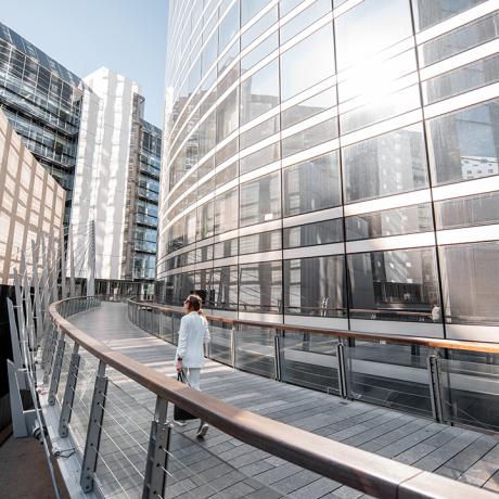 Woman walking along urban elevated path