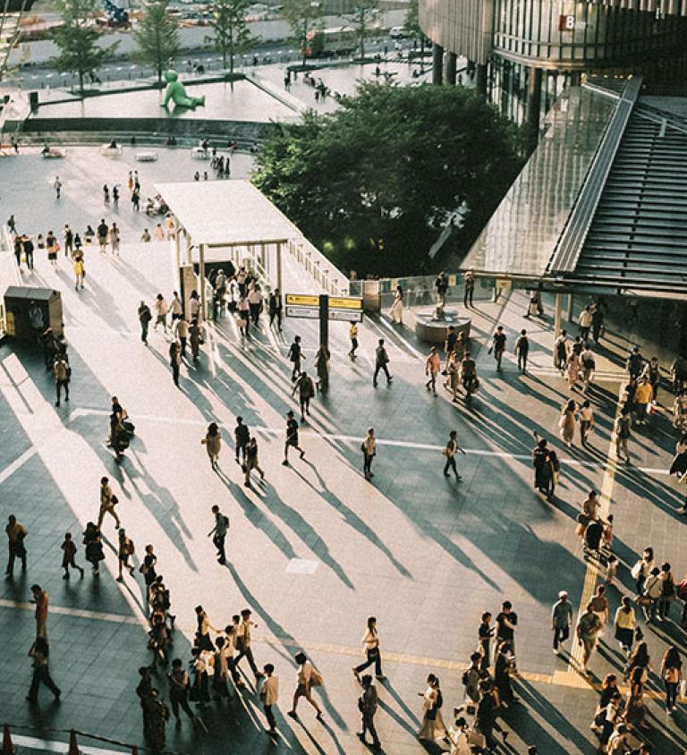 People walking across outdoor square